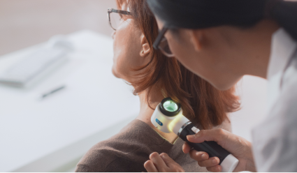 A clinician uses a medical device to inspect a patient's shoulder